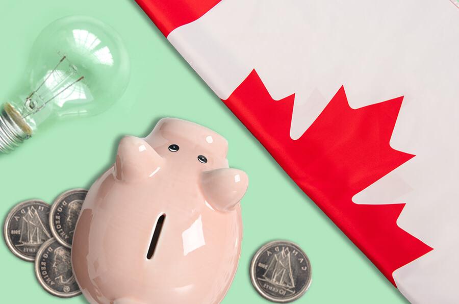 A Canadian flag, a pink piggy bank, a few Canadian coins, and a light bulb are arranged on a light green background.